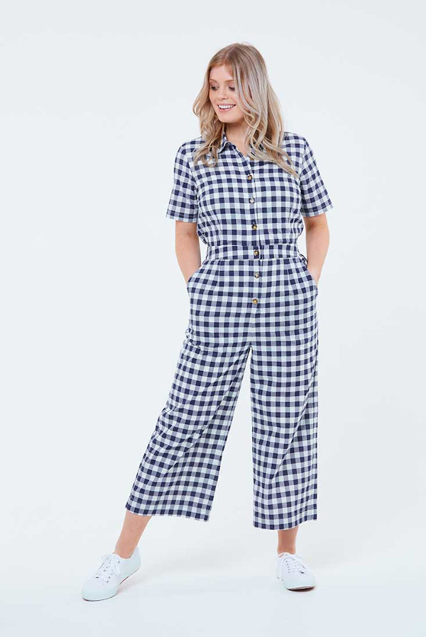 A woman wearing a check boiler suit with pockets