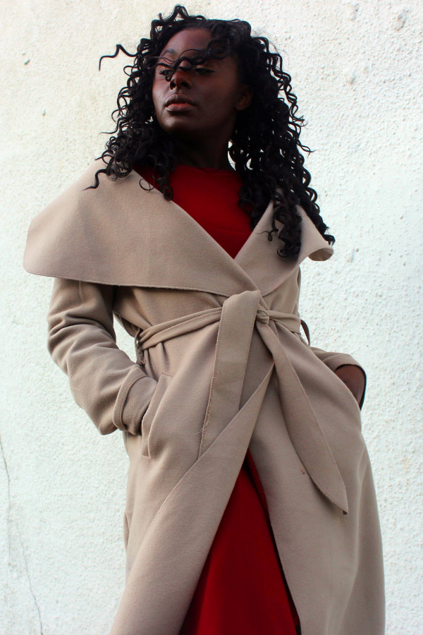 a woman wearing a coat with pockets